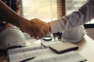 Commercial plumber shaking hands with real estate developer